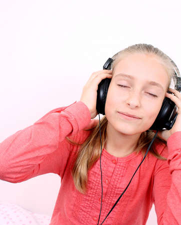 Blond happy girl listening to music with headsetの写真素材