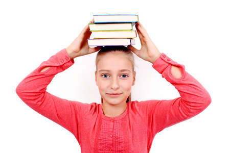Enthusiastic girl with four books on head