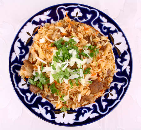 Cooked oriental risotto, meat with rice closeup