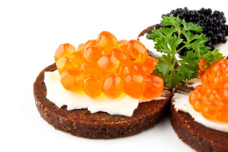 Pumpernickel bread topped with red caviar, closeupの写真素材