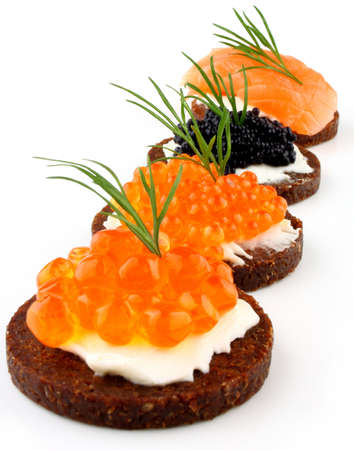 Black bread with salmon, trout and sturgeon caviar, close upの写真素材