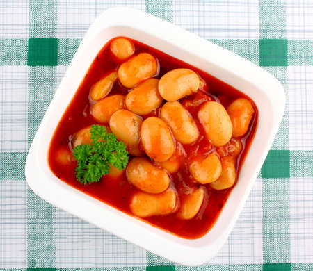 Giant white beans in tomato sauce, close upの写真素材