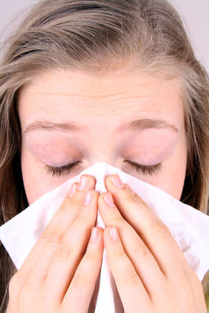 Girl blows her nose with handkerchief, health concept, closeup