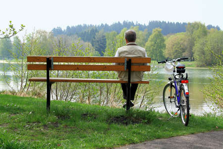 Mature man sitting relaxing after cycling as backgroundの写真素材