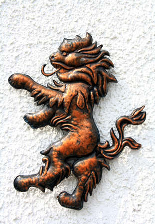 Lion bronze figure on the white wall, close upの写真素材