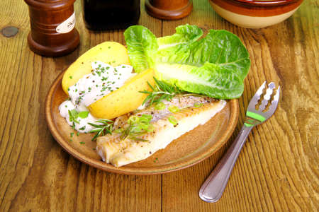 Fish, potato with cottage cheese, salad and fork, close up