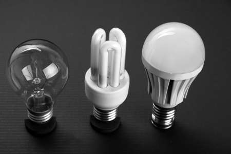 Ancient and modern LED lamp on black background, close upの写真素材