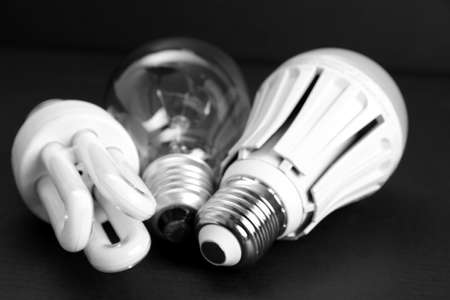 Ancient and modern LED lamp on black background, close upの写真素材