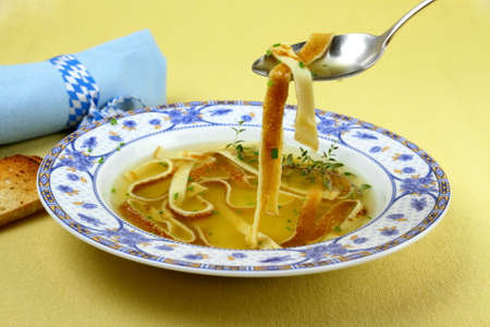 Pancake soup in blue plate, eating, close upの写真素材