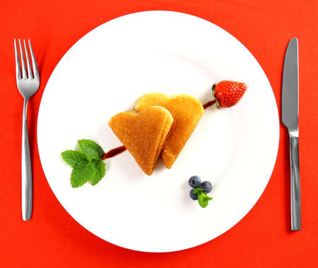 Two pancakes heart and chocolate, strawberry, mint arrow, top viewの写真素材