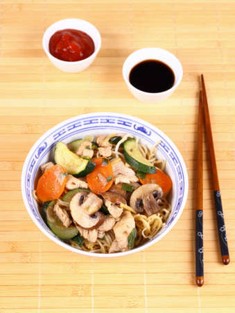 Chicken meat in china pan-asian noodle with vegetables, top viewの写真素材
