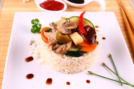 Chicken meat, asian rice, zucchini, carrots, sauces, close upの写真素材