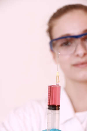 Girl student with large syringe, soft focusの写真素材