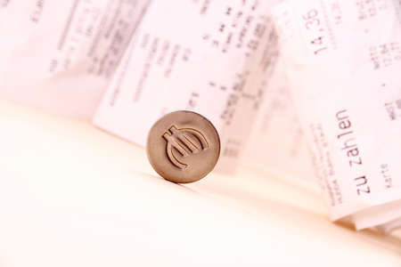 Euro symbol rolled down bills in background, close upの写真素材