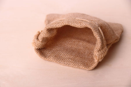 Empty jute sack on wood background, horizontal