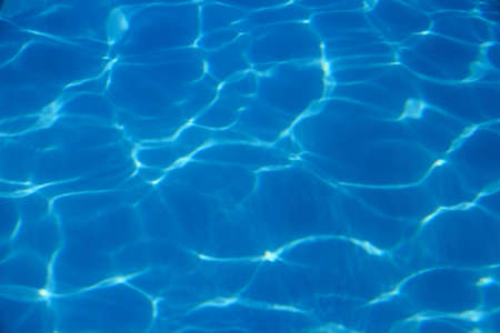 Blue waves in swimming pool as background, top view