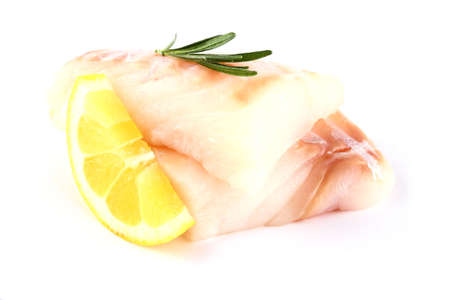 Cod fish fillet with lemon, rosemary on white, isolatedの写真素材