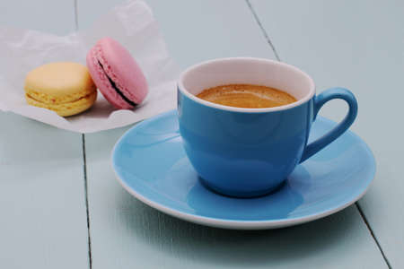 Blue Espresso Cup and two macarons, close up