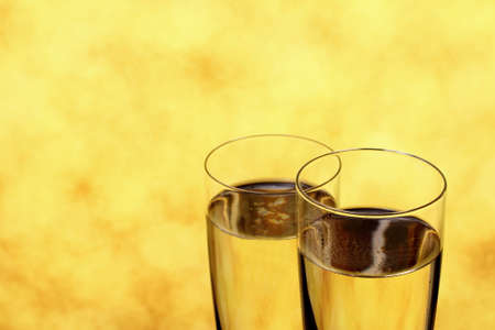 Two Champagne glasses as wedding rings symbol, blurred backgroundの写真素材