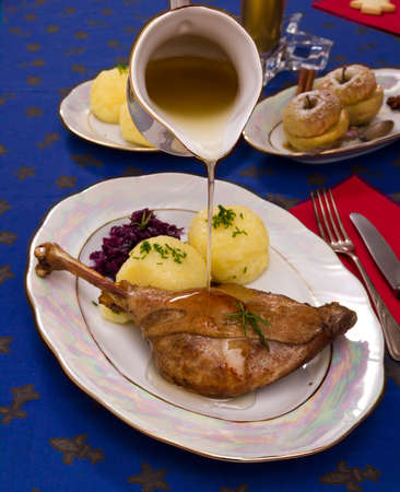 Roasty duck leg with braised red cabbage and dumplings top viewの写真素材