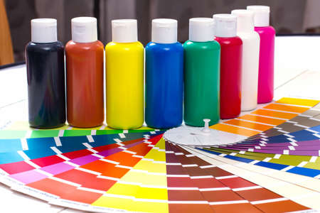 color palette tubes of paint on white wooden background close up