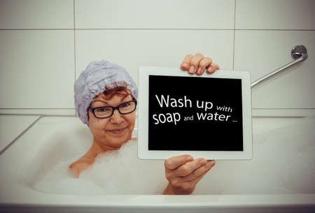 Woman in bathtub with tablet computers, retro style, space for text