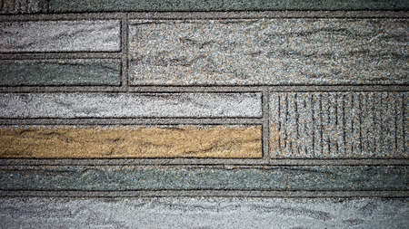 Old wall made of colored resin stone slabs as background, close upの写真素材