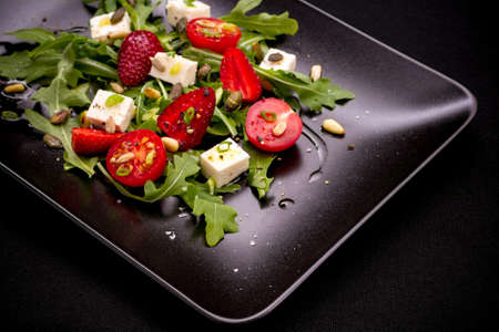 Strawberry tomato salad with feta cheese, olive oil, top view