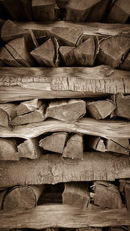 Neatly stacked wood as background, vertical