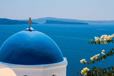Church Cupola in Santorini with flower, Greece, close upの写真素材