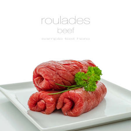 Three raw roulades beef isolated on white plate, close upの写真素材