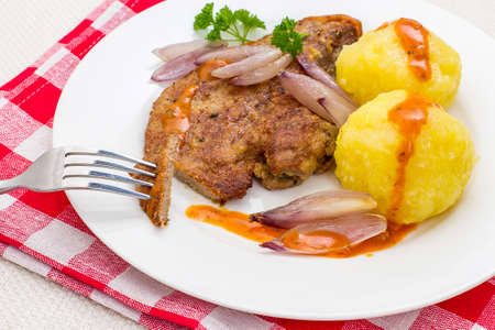 Fried calf's liver with shallots and potato dumplings, top viewの写真素材
