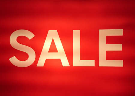 Sepia text sale from fluorescent lamp on red background, soft focusの写真素材