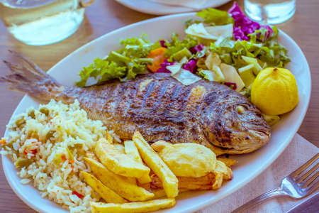 Bream with potato, rice and salad, mediterranean foodの写真素材