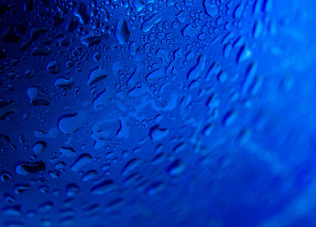 Water drops on radial blue background, soft focus, close upの写真素材