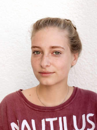 Cute girl portrait in red T Shirt on white backgoundの写真素材