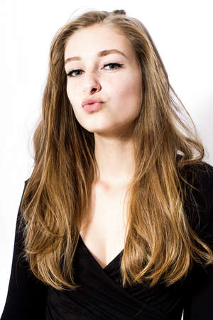 Portrait of young girl gives kiss, isolated