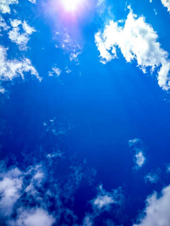 Beautiful blue sky with clouds and sun as background