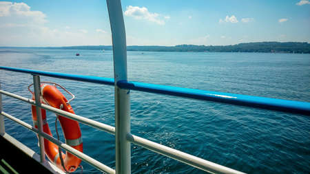 Lifebuoy on board ship at blue sky backgroundの写真素材