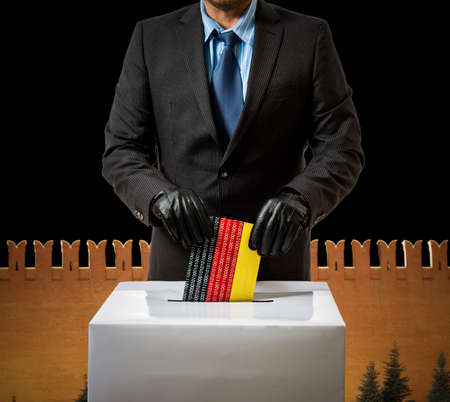 Man with glove throws German flag in voice box, federal electionsの写真素材