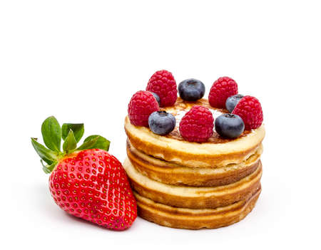 Pile of pancakes with berries, isolated