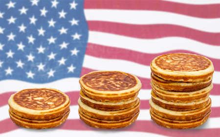 Pancakes as a stack of money on the USA flagの写真素材