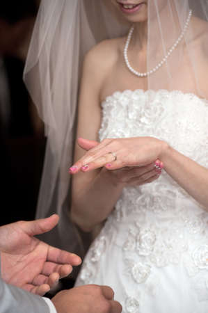 The ring exchange by the bride and groom, how the bride, joy filled to intently To confirm the bridal ringの写真素材