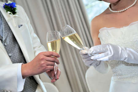 Toast scene, unveiling at your wedding reception of aligned two people, the bride and groom come welled up is joyの写真素材