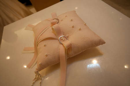 Very nice elegant placed in a romantic wedding table wedding ring and a ring pillowの写真素材