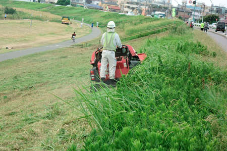 Mowing, Banks of the riverbed after mowing languages by mowerの写真素材