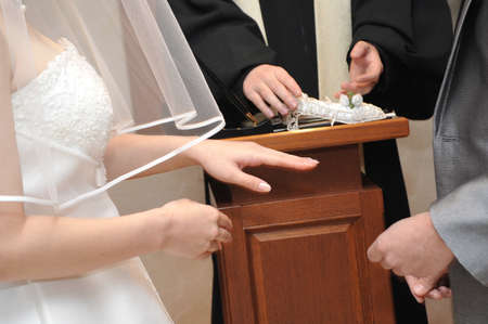Ring exchange scene from the groom to the brideの写真素材