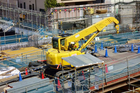Redevelopment construction site in urban downtown with heavy equipment
