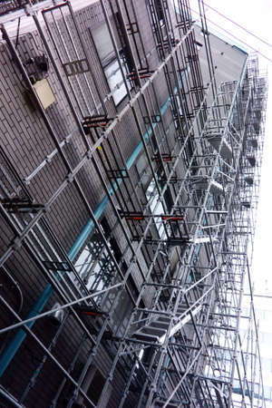 A building with scaffolding for demolition, renovation, and repair workの写真素材