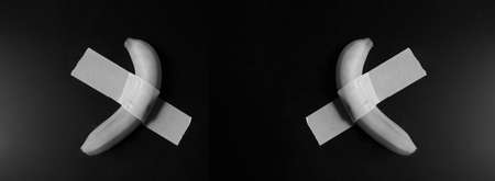 Symmetry, a delicious looking amazing banana taped to the wallの写真素材